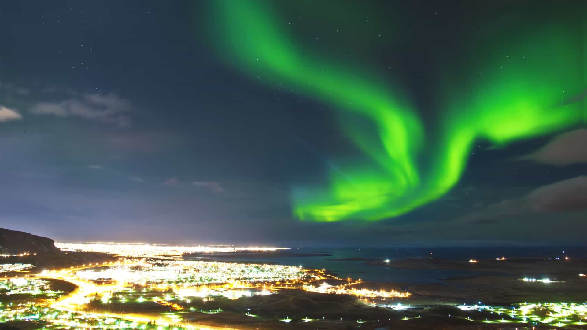 Witness the magical Arctic Circle Northern Lights from Reykjavik, Iceland, on a Norwegian cruise adventure.