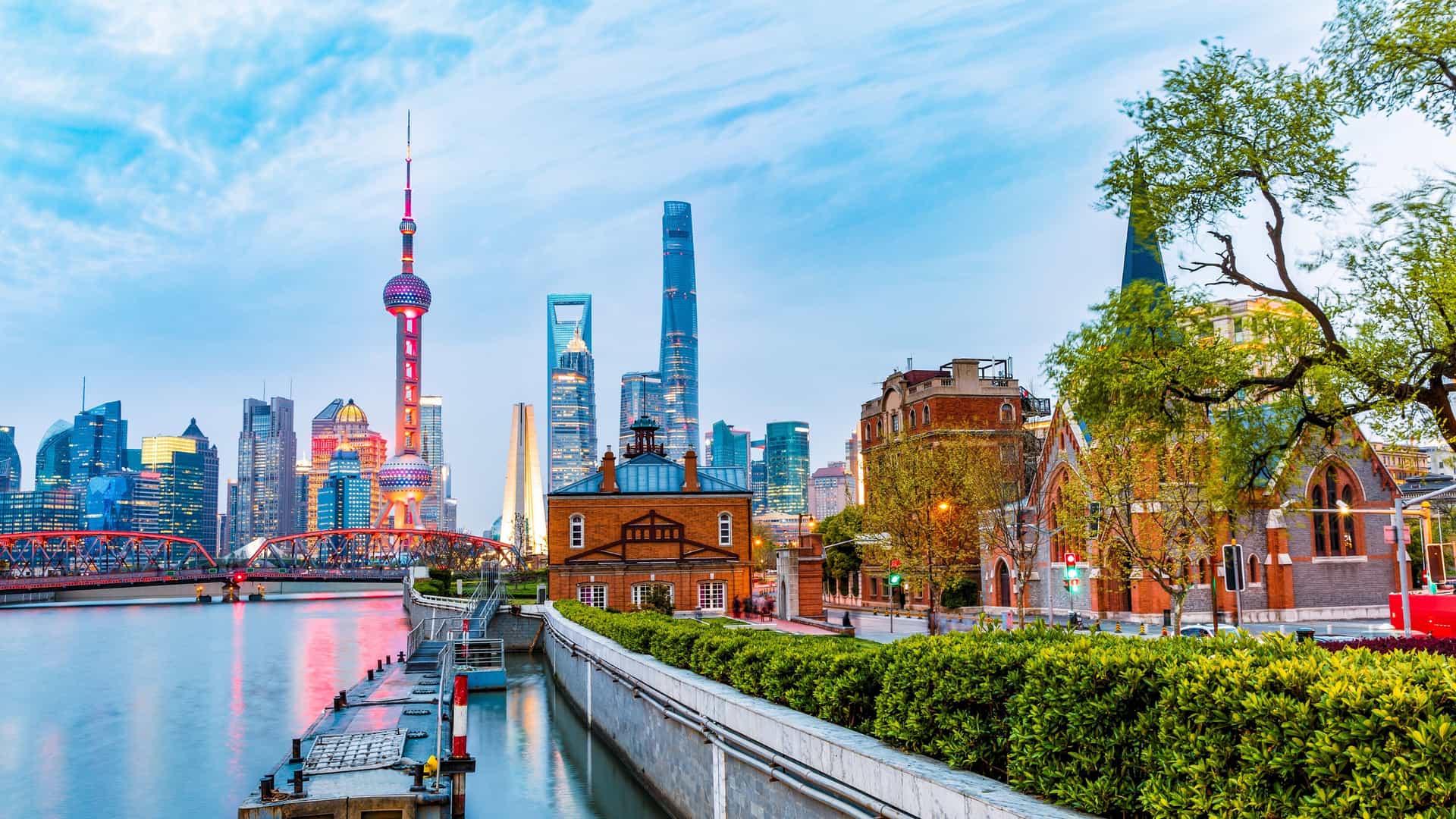 Norwegian Cruise Line guests enjoy the breathtaking Shanghai skyline in China, showcasing the modern Pudong skyscrapers and historic Bund architecture along the Huangpu River.