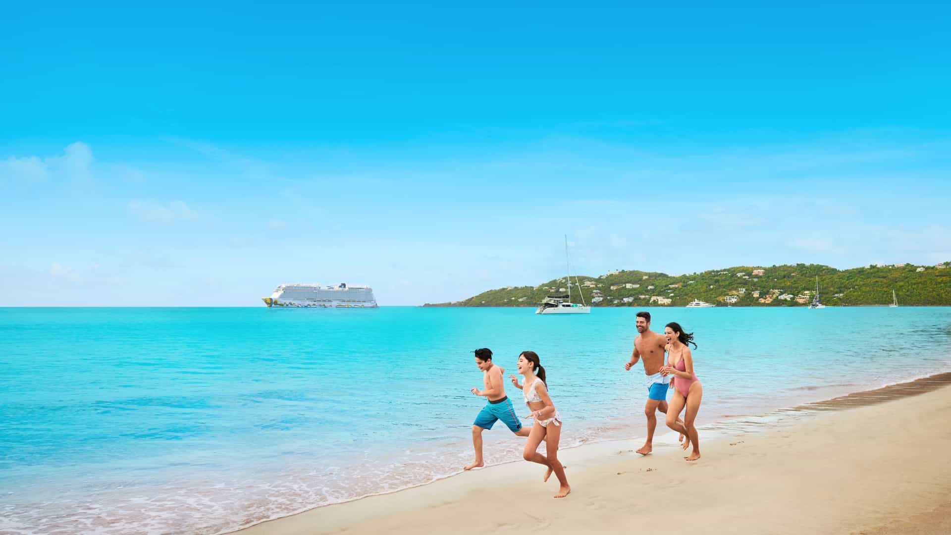 A family enjoys a fun day running on the beautiful white sands of Megan's Bay in St. Thomas, US Virgin Islands, with a Norwegian Cruise Line ship in the background.