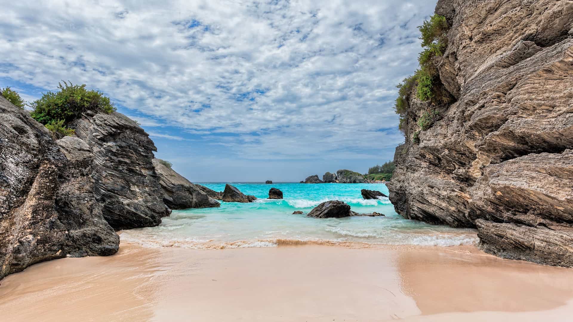 A beautiful view of the famous pink sand and turquoise water at Horseshoe Bay Beach in Bermuda, a popular port of call for Oceania cruises.