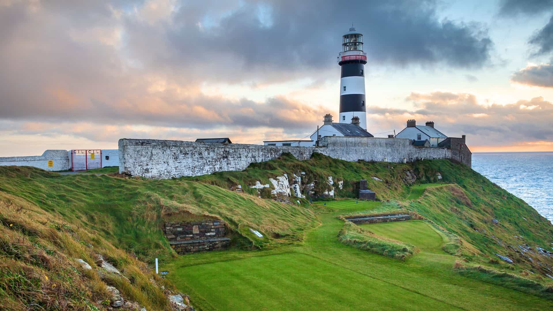 The lighthouse at the 18th hole at the Old Head Gof=lf Course on the coast of County Cork in Ireland.