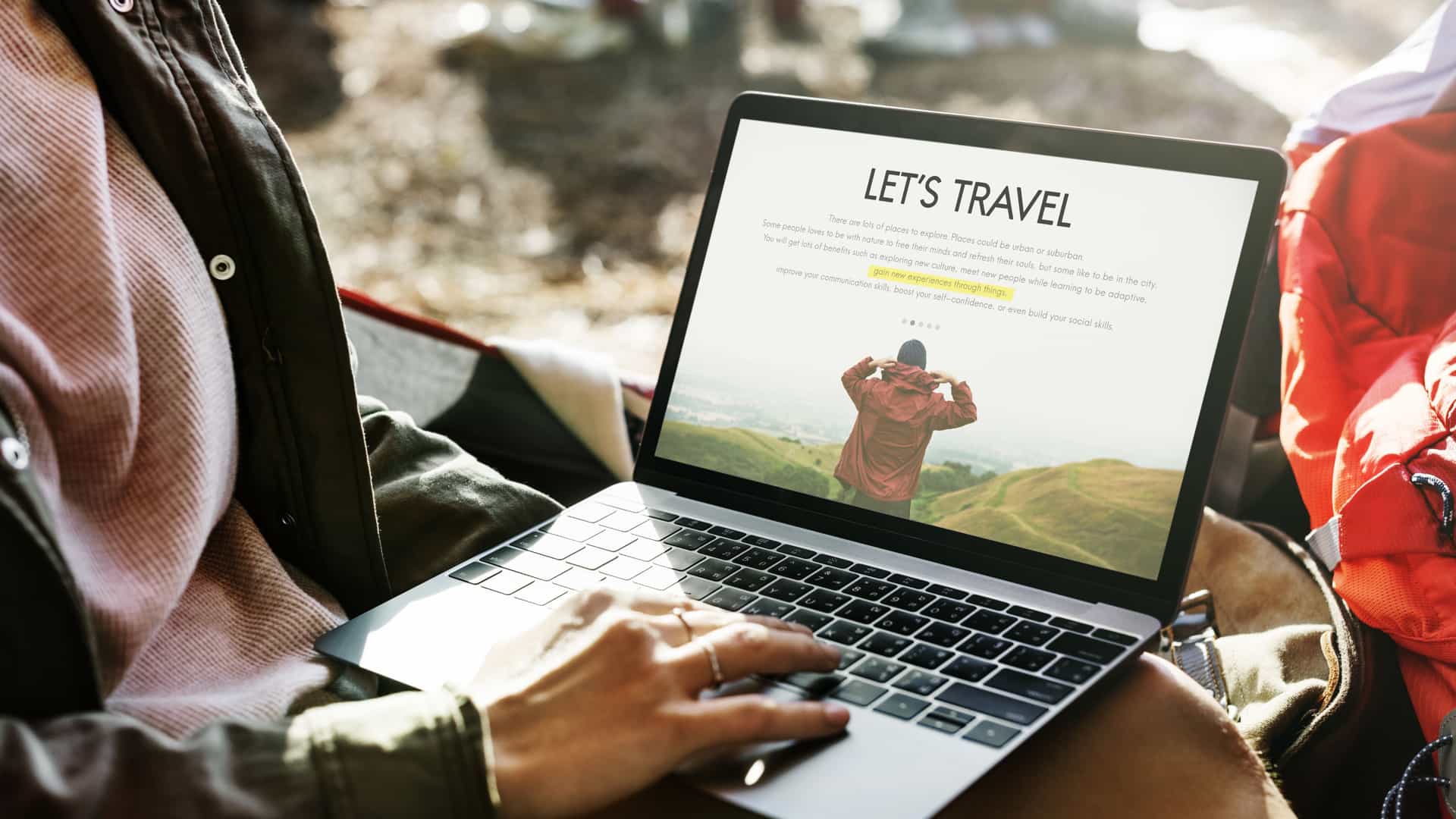 A close up of a person looking at a travel webpage on their laptop.