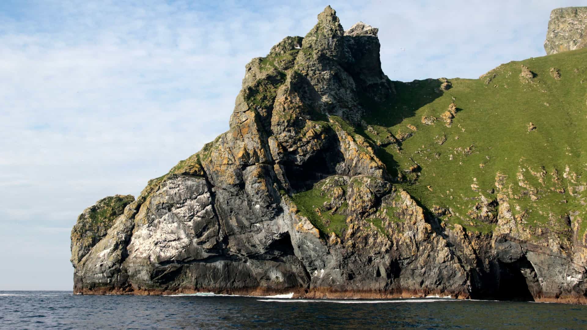 A massive, rocky sea stack on the uninhabited island of Boreray, a major gannet nesting site in the remote St. Kilda archipelago of Scotland.