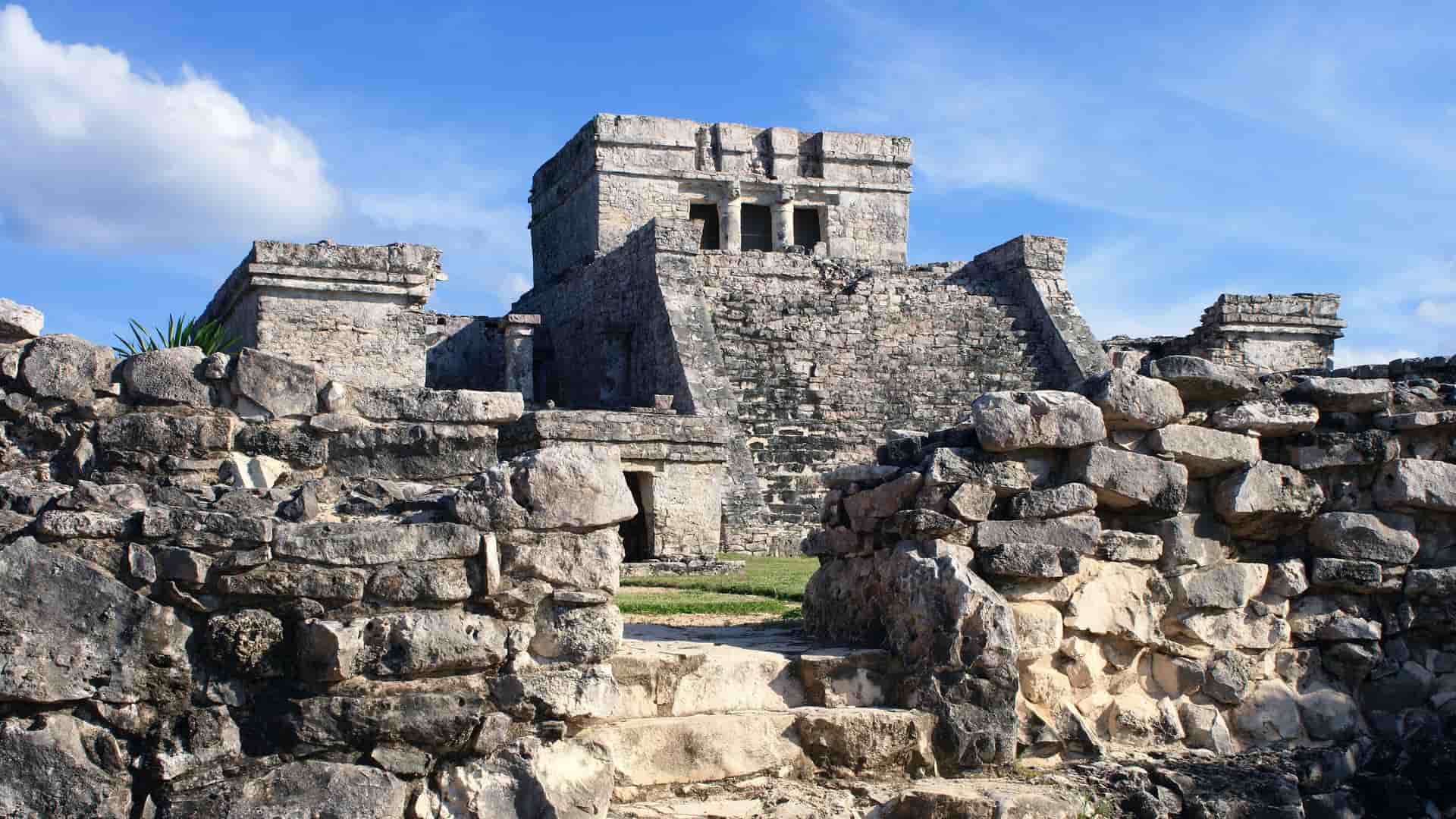 The ancient stone ruins of a majestic Mayan temple or pyramid, featuring historic architecture at an archaeological site in Mexico's Costa Maya region.
