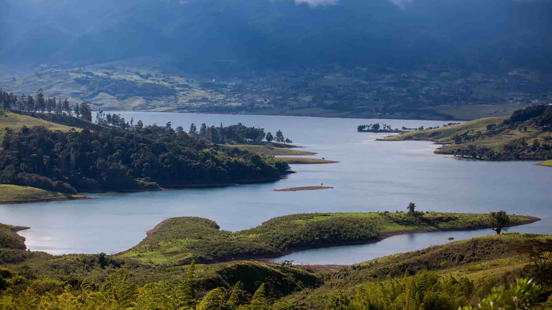 Scenic aerial view of Lago Calima reservoir nestled among the green hills and Western Andes Mountains in Darién, Colombia.