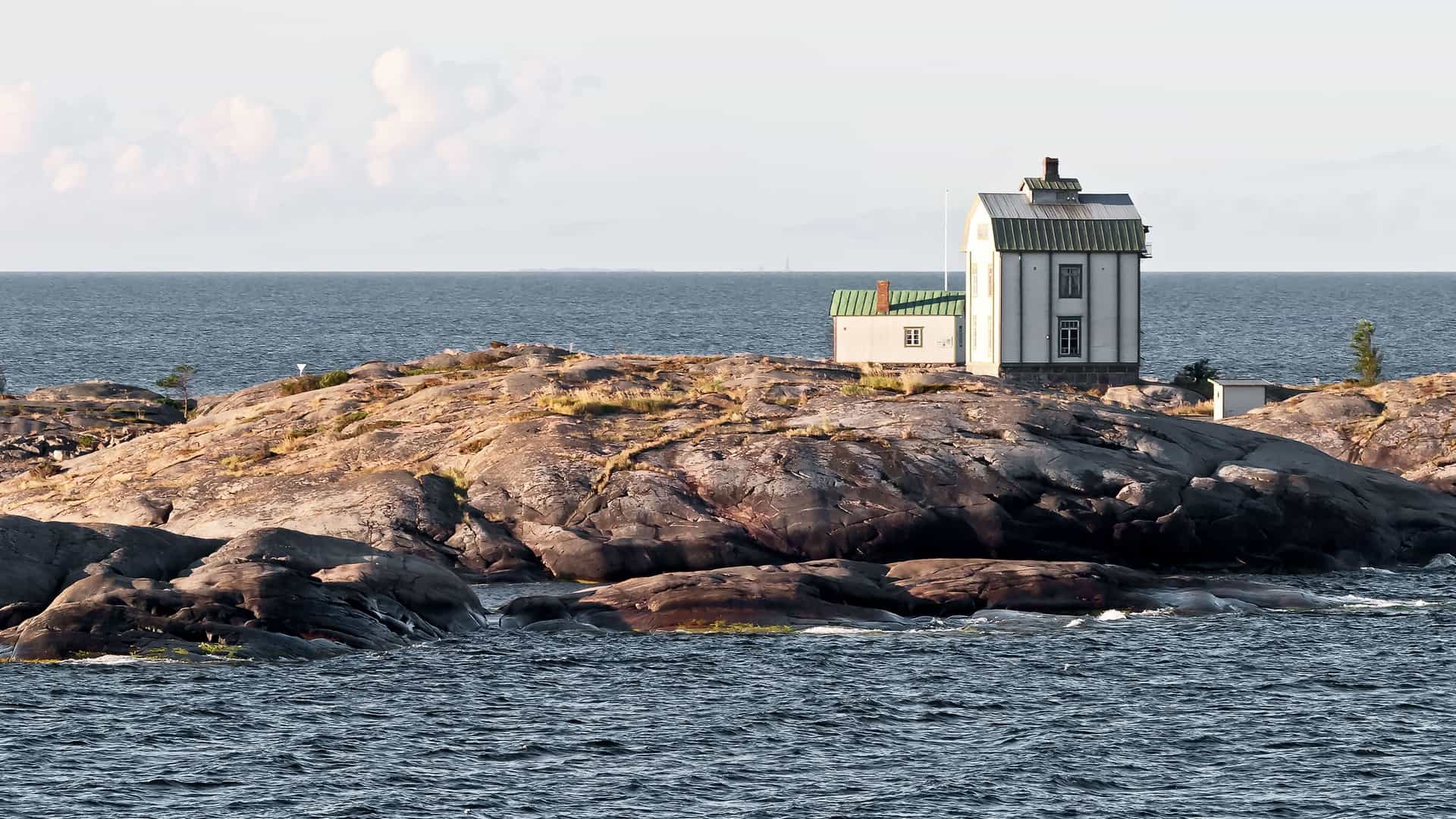 A charming white building on a rocky island in the Baltic Sea, a picturesque landmark near the port of Mariehamn, Åland Islands.