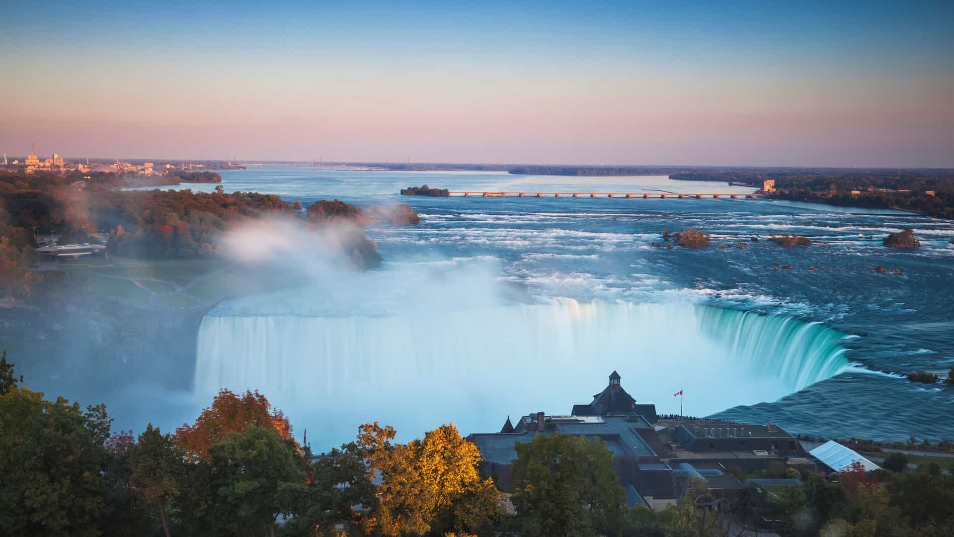 "A beautiful sunset panoramic view of the majestic Horseshoe Falls and the Niagara River from the Ontario, Canada side. "