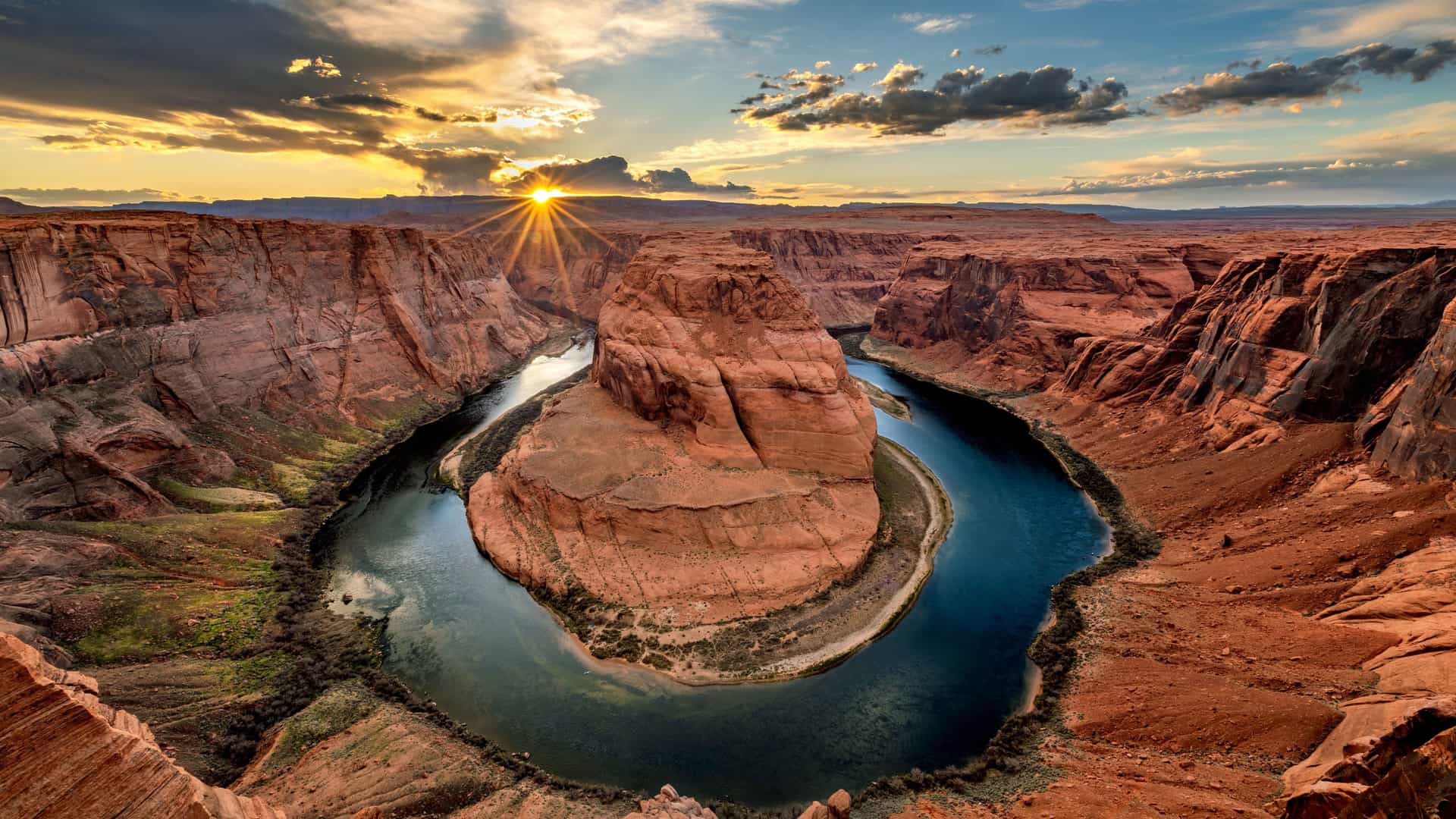 "A wide-angle landscape shot of the scenic Horseshoe Bend, a U-shaped meander of the Colorado River, in Page, Arizona, at sunset. "