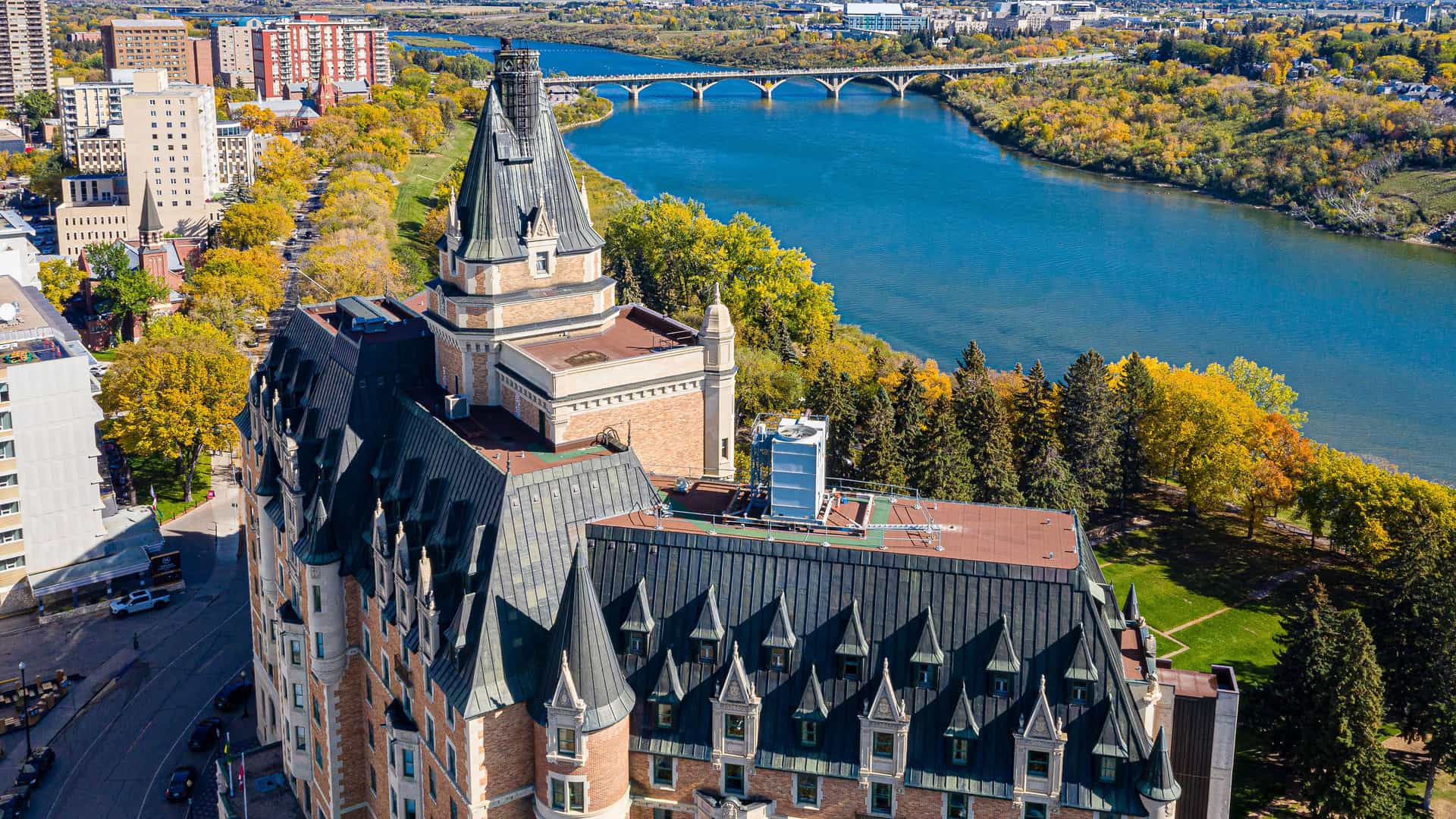 An aerial view of the historic Delta Bessborough Hotel with its chateau-style architecture, located on the banks of the South Saskatchewan River in Saskatoon, Canada.