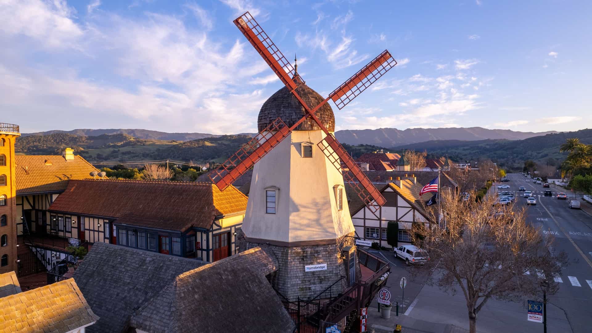 "An aerial view of a traditional Danish windmill in the charming town of Solvang, California, with its unique Scandinavian-style architecture, nestled in the Santa Ynez Valley. "