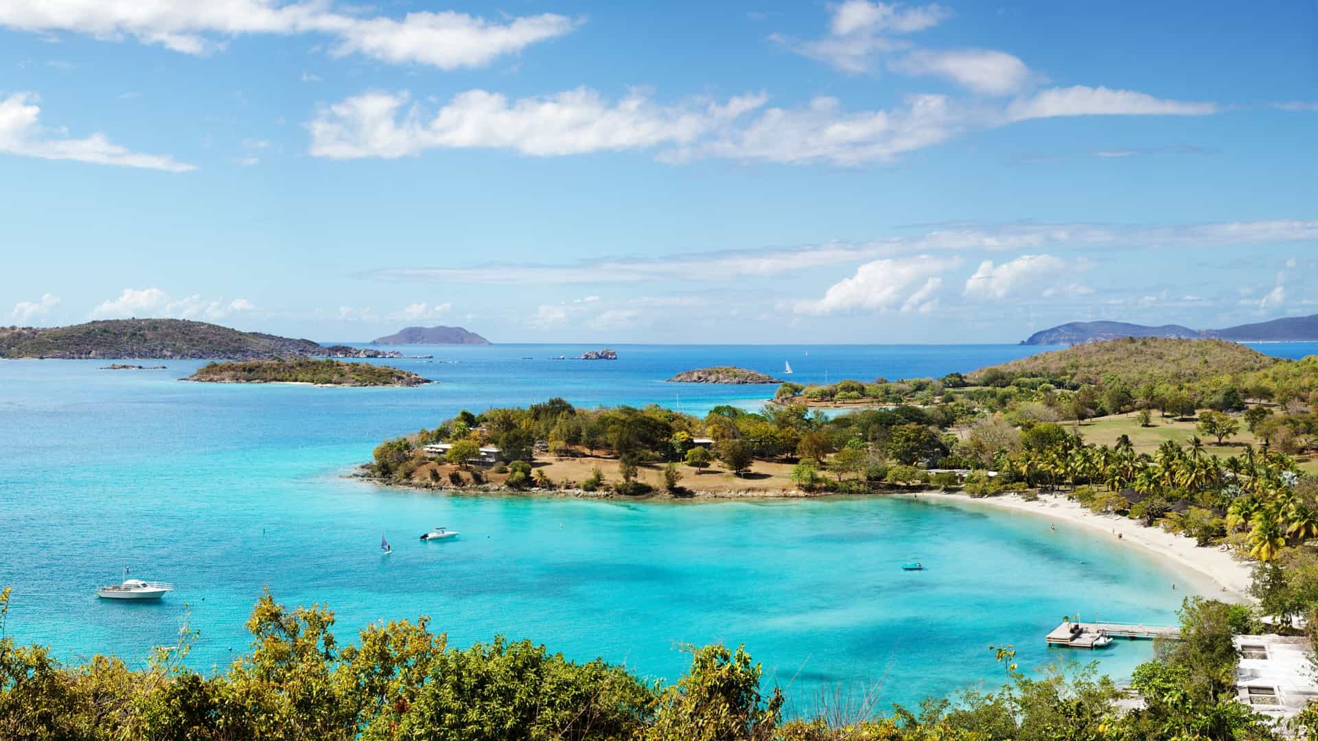 Stunning panoramic view of Caneel Bay in St. John, with its pristine beach and turquoise waters, a highlight of Princess Cruises' Caribbean destinations.