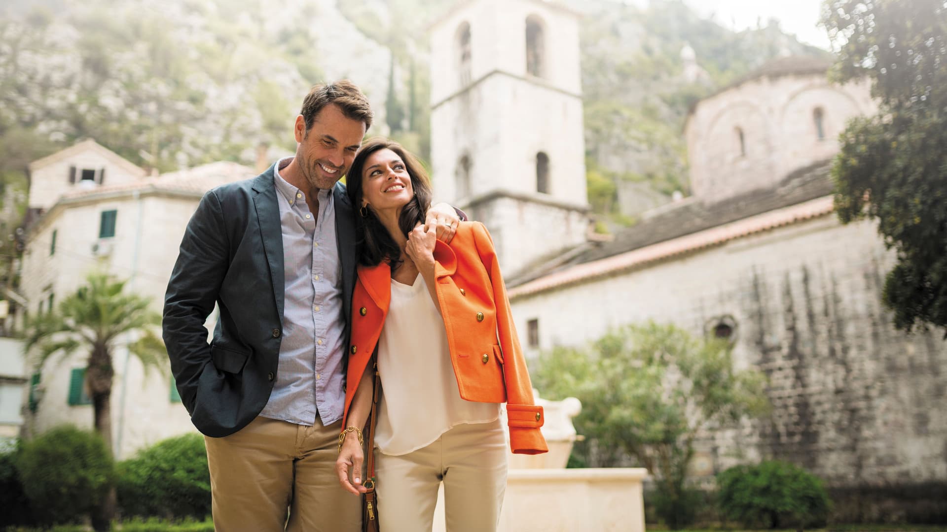 A couple walking through Kotor, Montenegro on an exciting shore excursion during their Regent Seven Seas cruise.