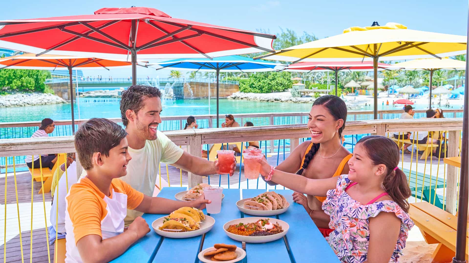 A family of four dining at Skipper's Grill at Cococay, Royal Caribbean's private island.