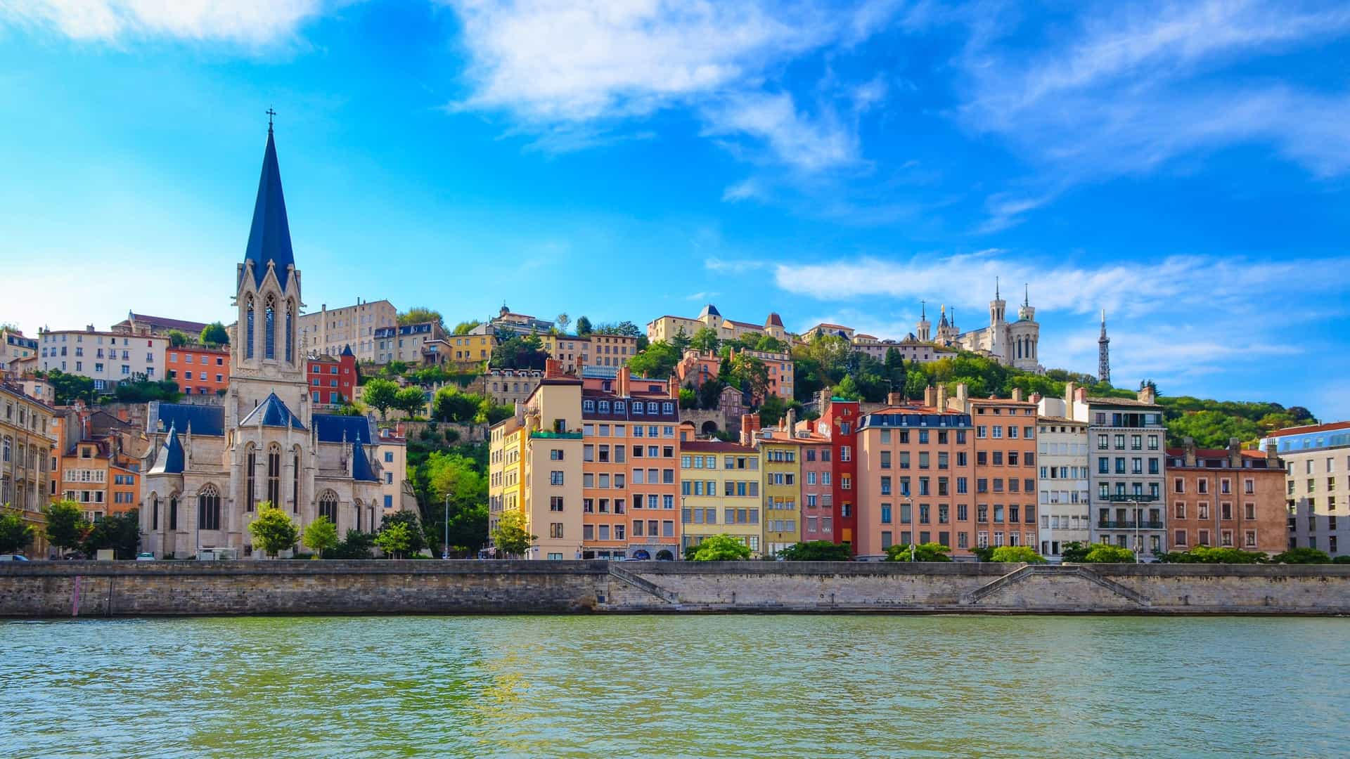A panoramic view of Lyon, France, showcasing the Saône River flowing through the cityscape.