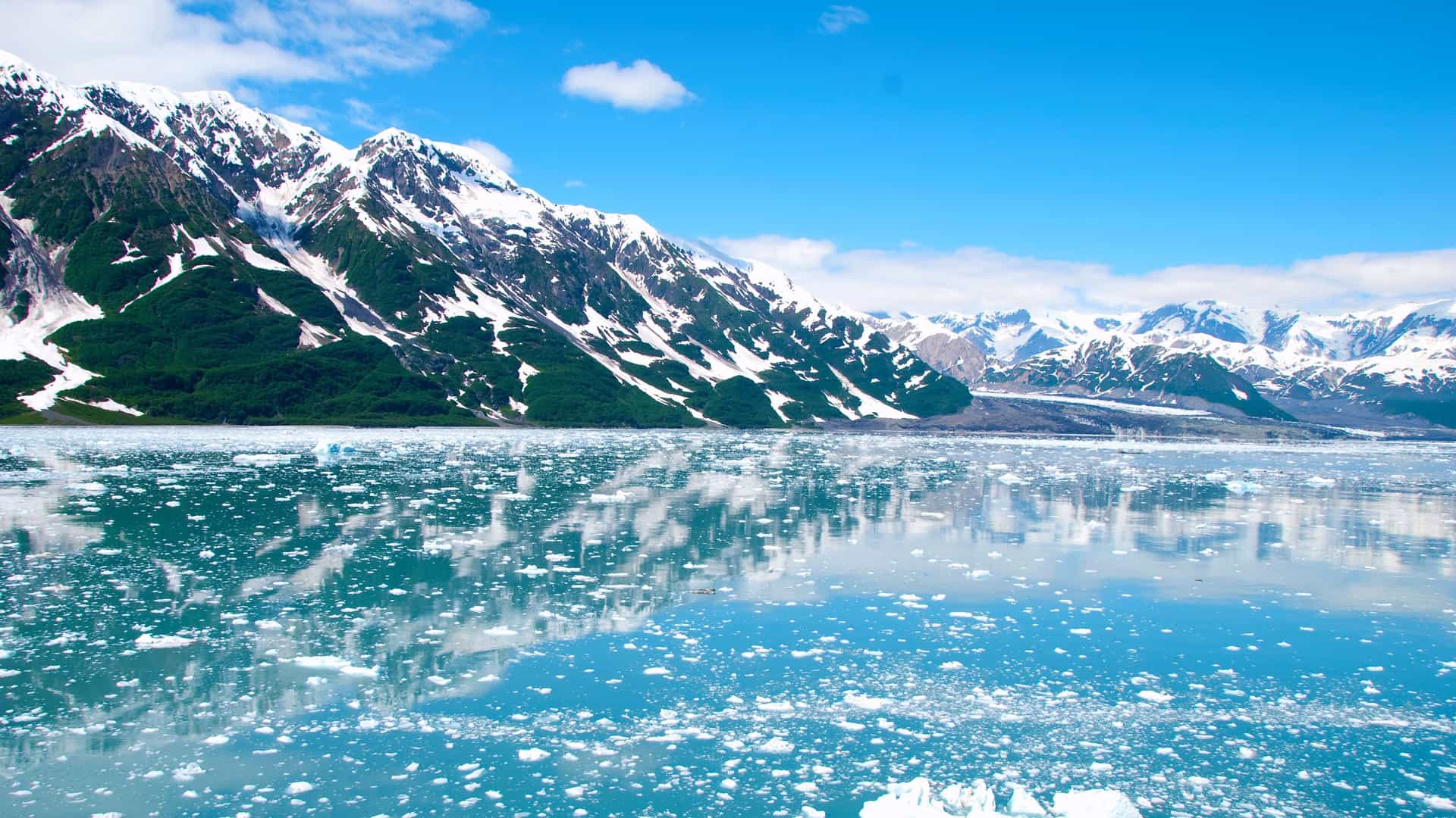 A breathtaking view of a glacier meeting the water in an Alaskan fjord, a scenic highlight of a Seabourn luxury cruise to Alaska.
