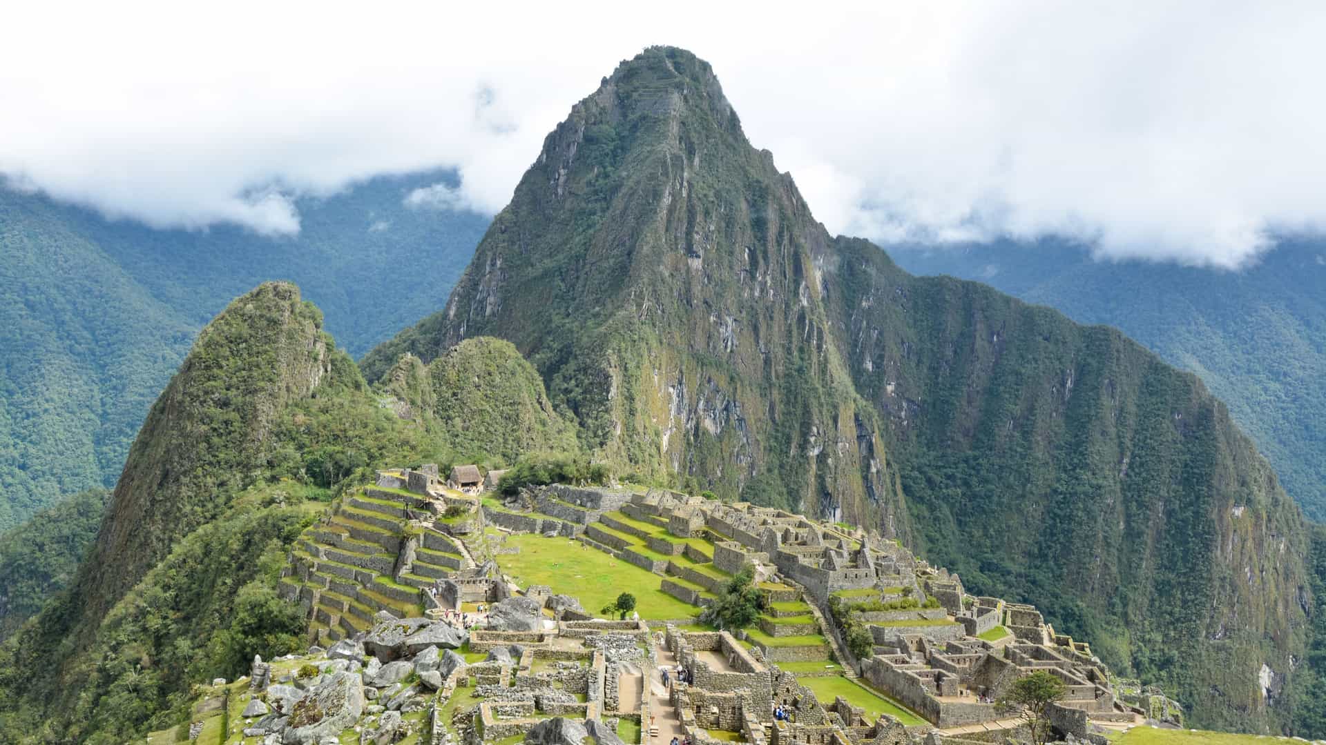 Panoramic view of the ancient Inca citadel of Machu Picchu nestled among dramatic Andean Mountain peaks in Peru on a Tauck land journey.