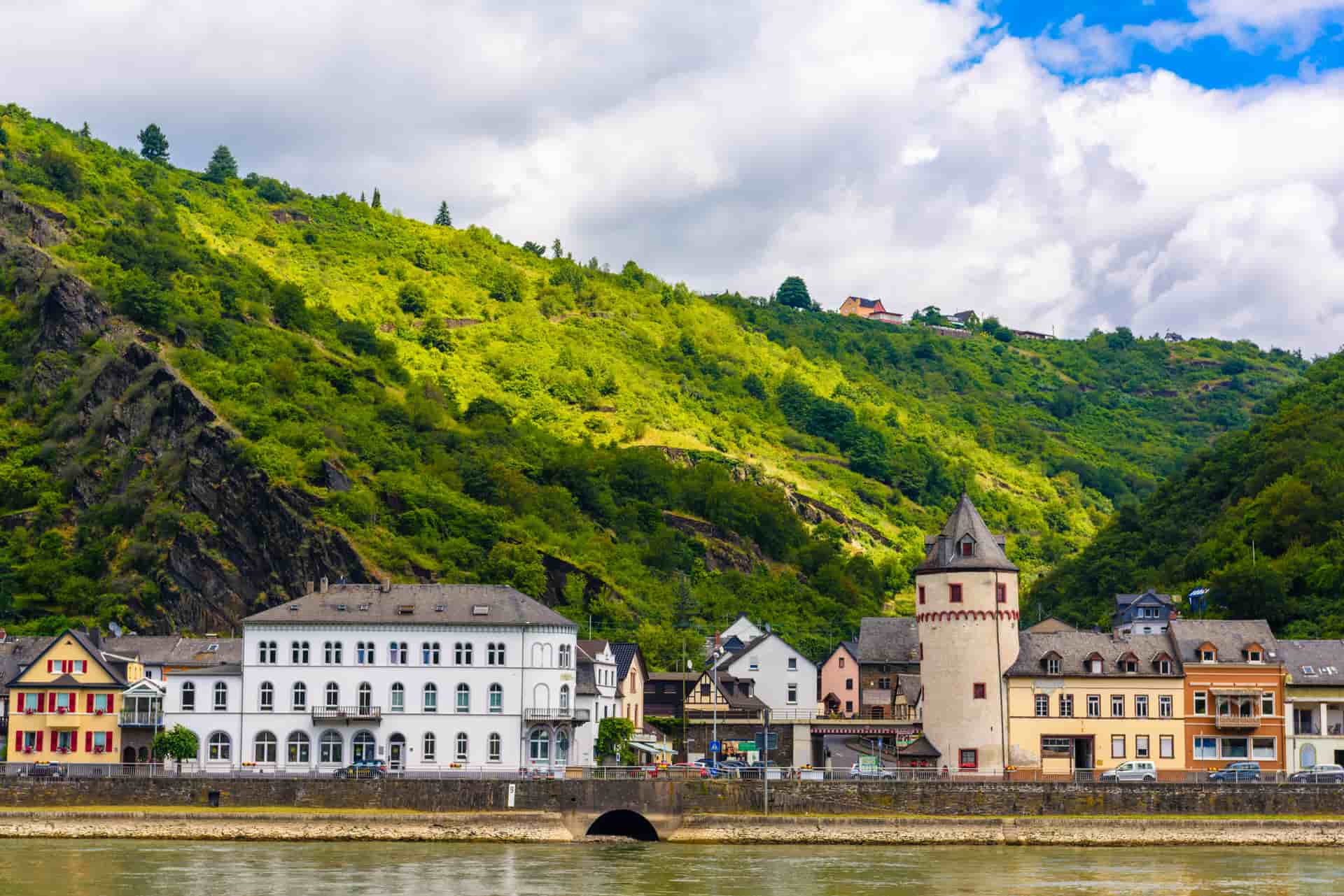A beautiful waterfront view of the historic town of Sankt Goarshausen nestled along the Rhine River in Germany—a classic cultural shore excursion destination located near the famous Loreley rock.