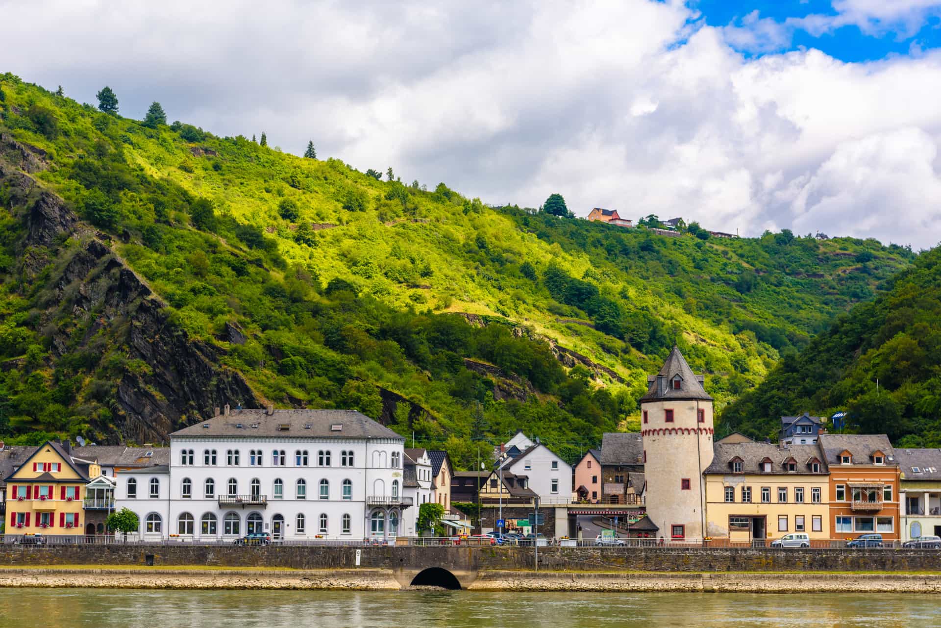 A beautiful waterfront view of the historic town of Sankt Goarshausen nestled along the Rhine River in Germany—a classic cultural shore excursion destination located near the famous Loreley rock.