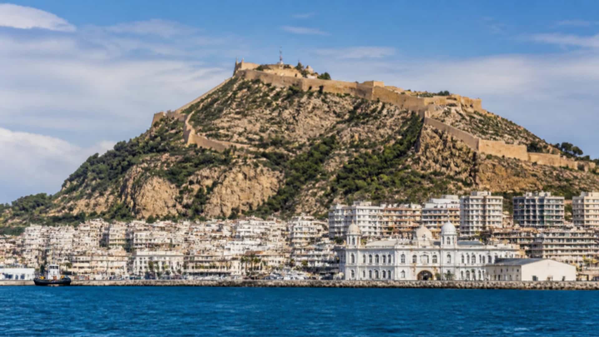 The Mediterranean waterfront of Oran, Algeria, with the Santa Cruz fortress atop Mount Murdjadjo rising above the bay.