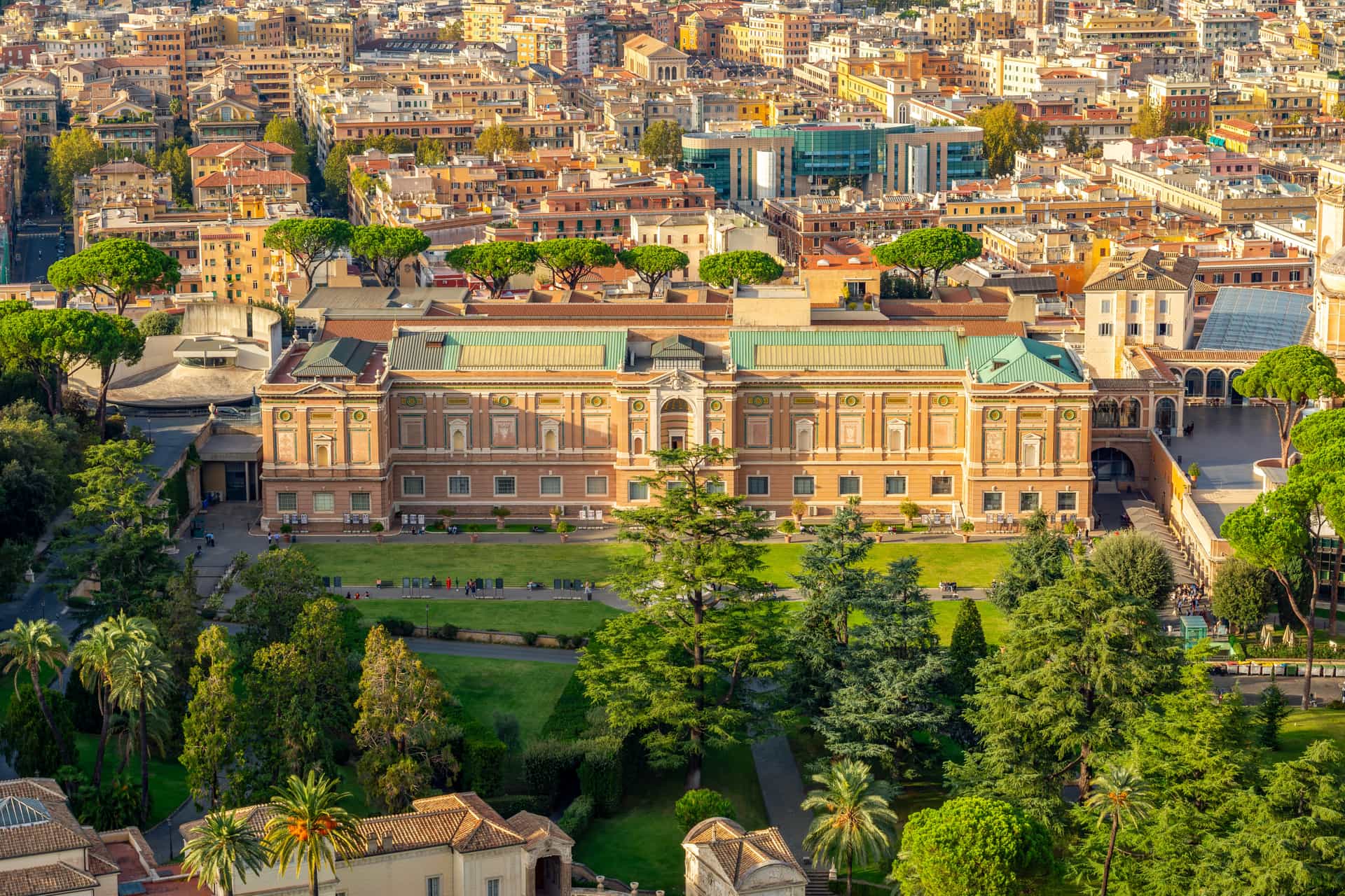 An aerial view of the Vatican Museums, gardens, and urban surroundings in Vatican City.
