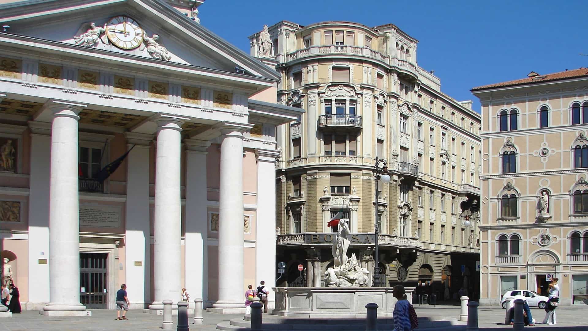 Palazzo Dreher building in a sunny Trieste, Italy square.