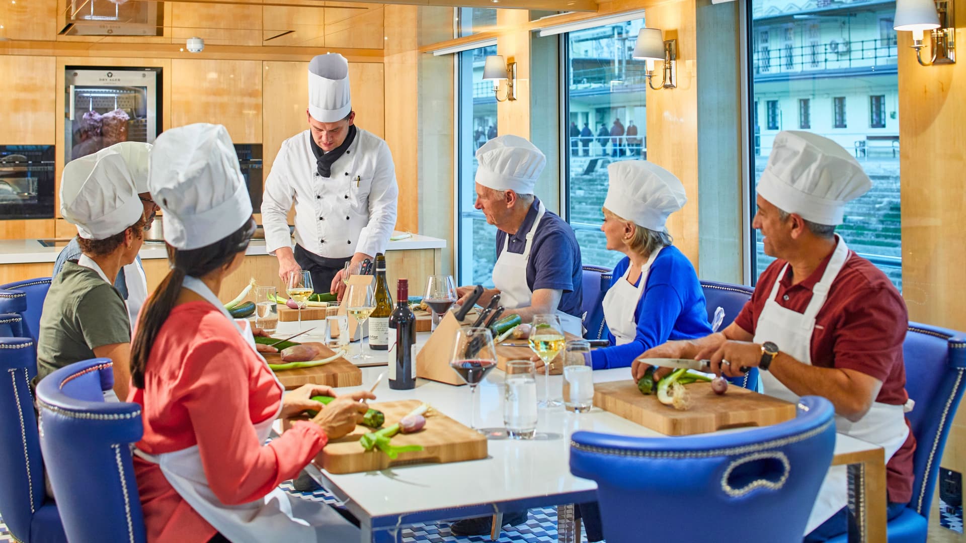 Guests taking a cooking class during a Uniworld river cruise.