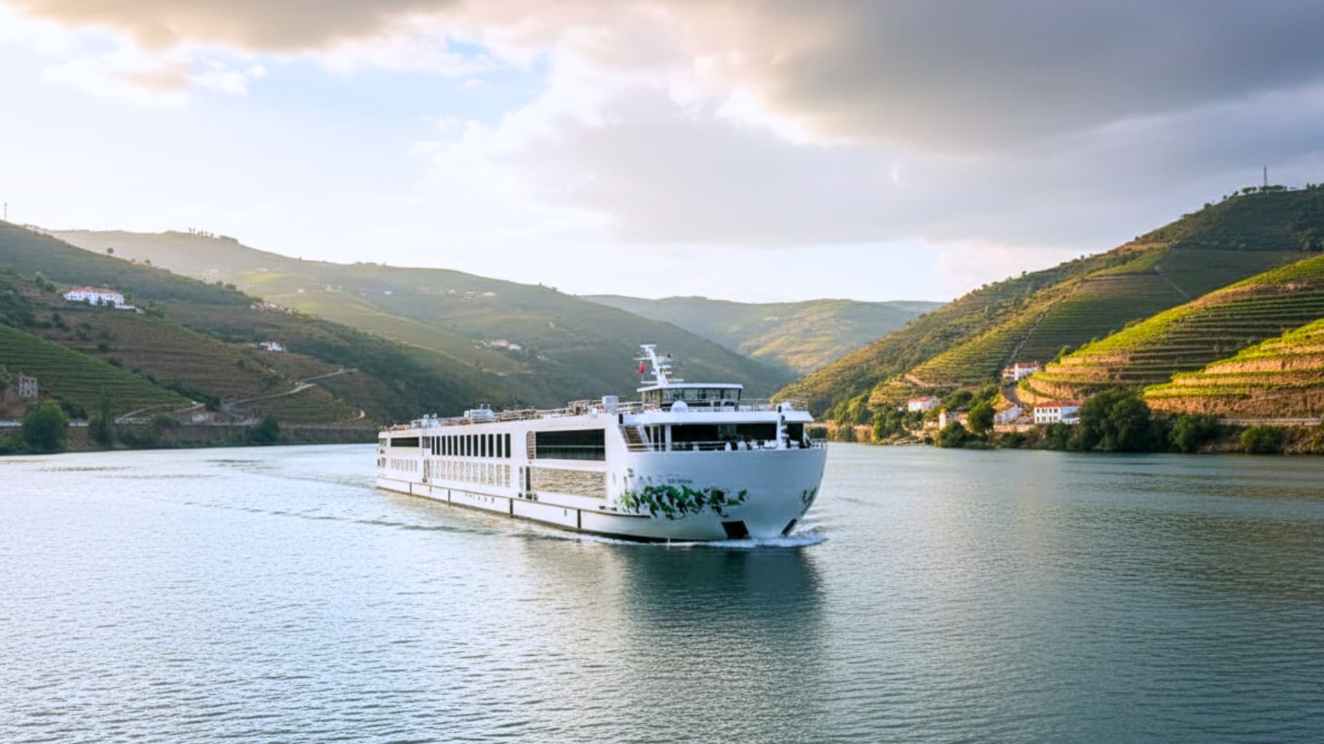 Uniworld S.S. São Gabriel river cruise ship exterior with a lucious green mountain range in the background.