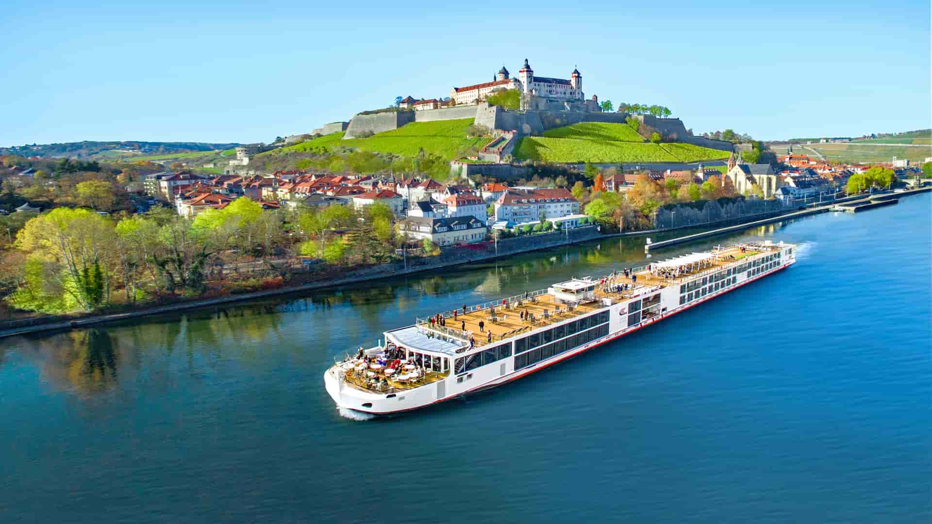 Viking Hild sailing a European River with a castle in the background.