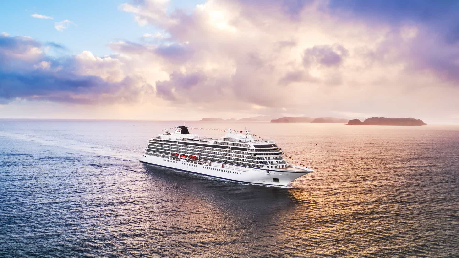 A Viking Ocean cruise ship sailing into the scenic Bay of Islands, New Zealand, a breathtaking destination on a Trans-Pacific itinerary.