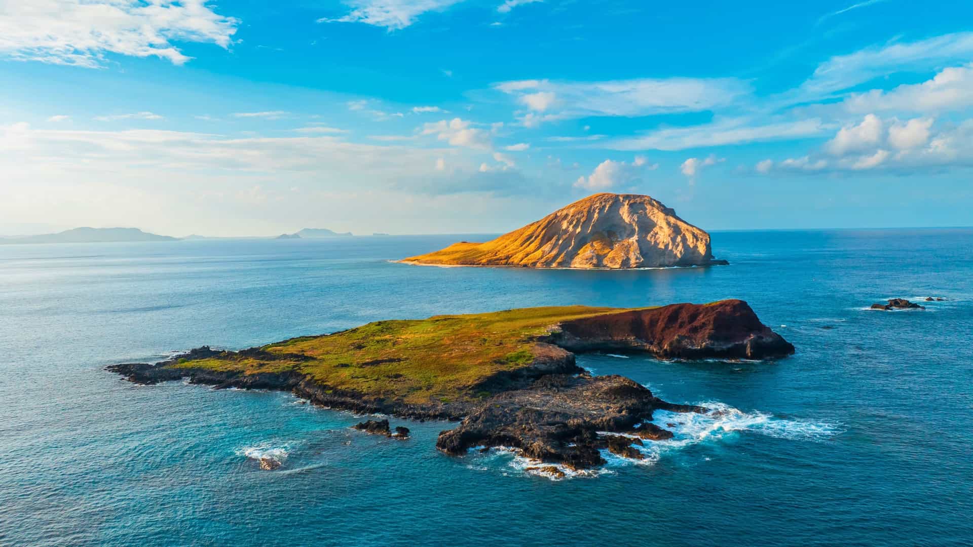 An aerial view of the Mokolua Islands off the coast of Lanikai Beach, Oahu, Hawaii, a stunning and iconic landscape for a Viking Ocean cruise to the islands.