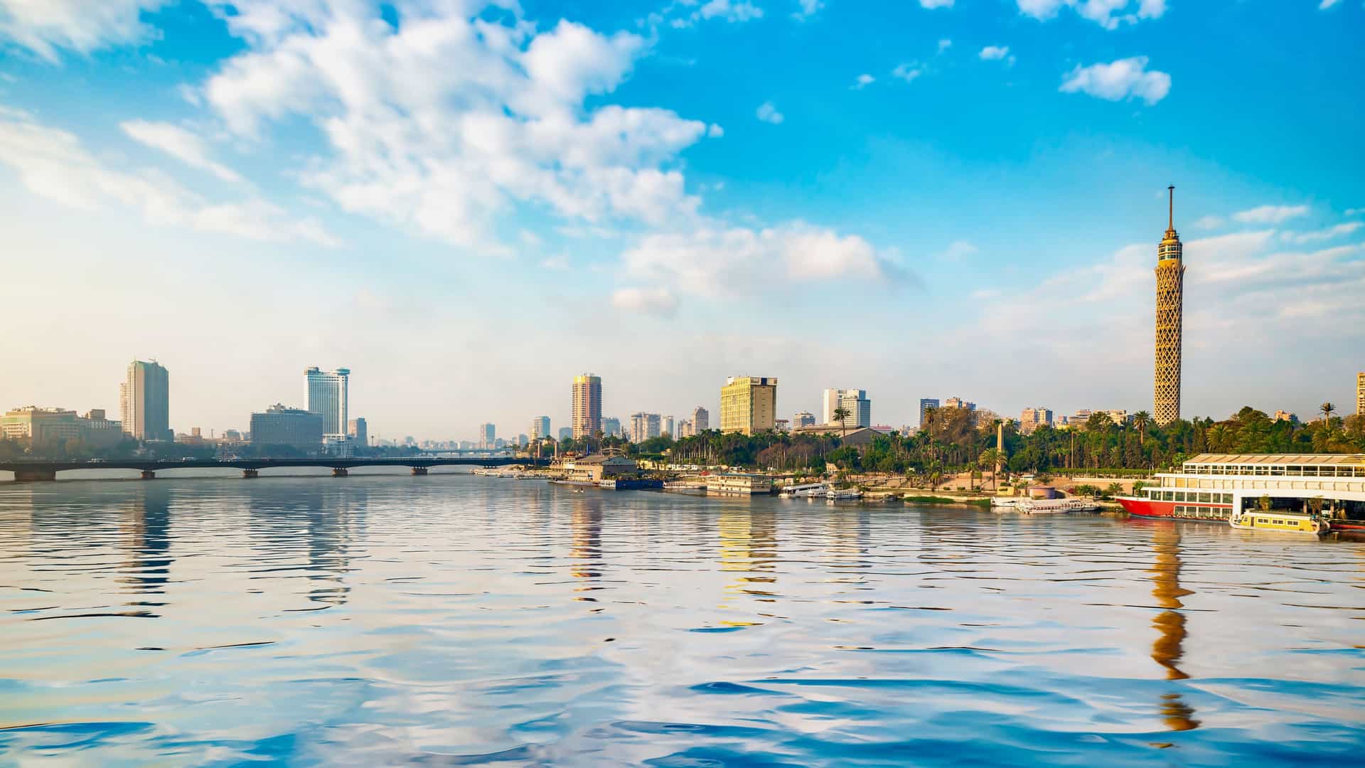 The modern skyline of Cairo, Egypt, including the iconic Cairo Tower, along the banks of the Nile River, a vibrant city to explore on a Viking River.