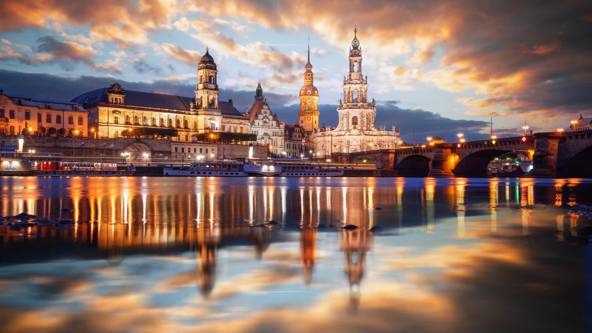The historic skyline of Dresden, Germany, at sunset, reflected on the Elbe River, a breathtaking view from a Viking River cruise.