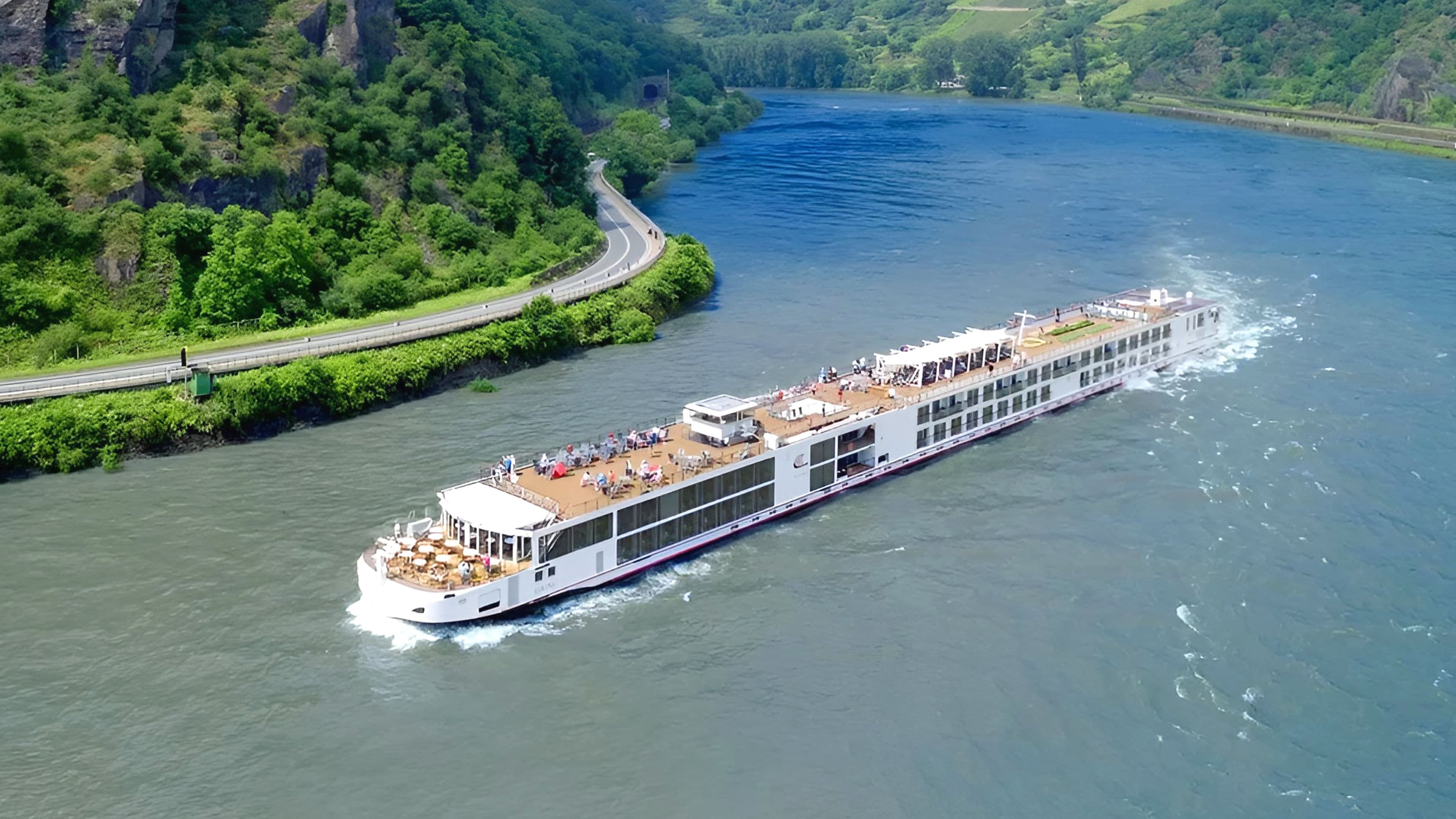 Viking Tir sailing a European river on a sunny day.