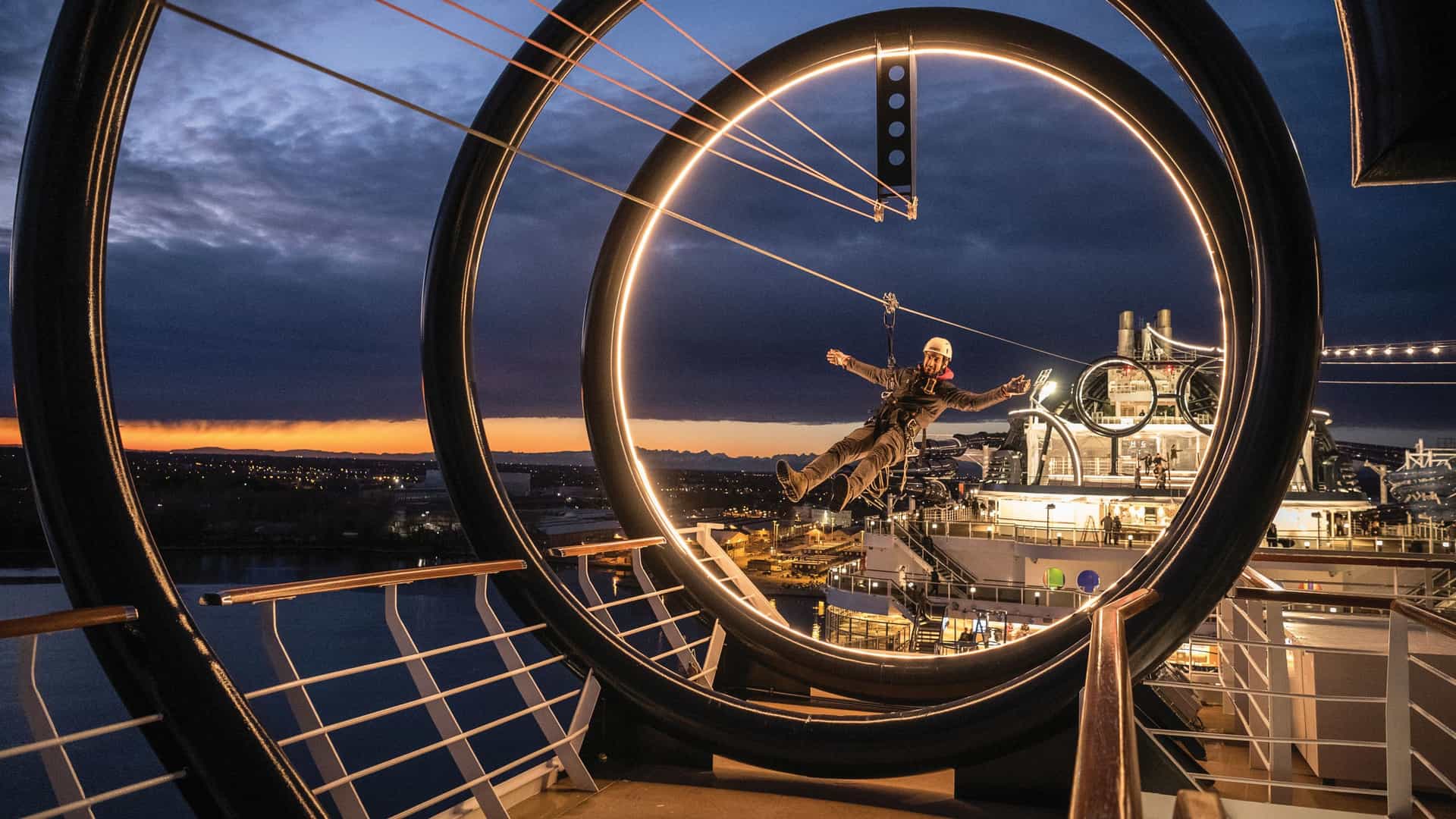 A harnessed cruiser ziplining across the onboard zip line of the MSC Seaside.
